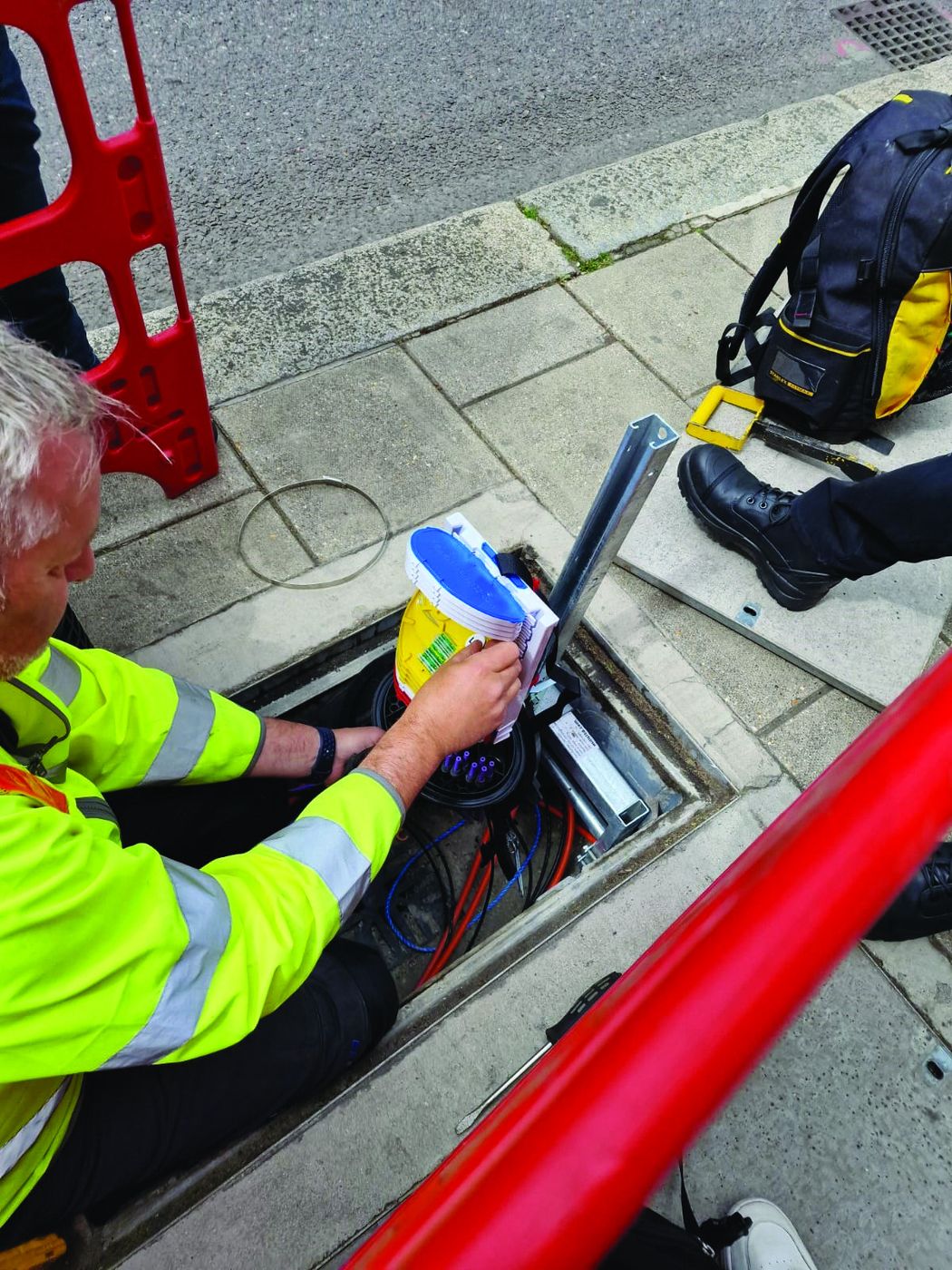 Engineer scanning a LOC tag inside a street chamber with a mobile phone