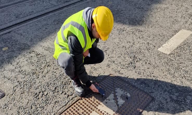 Engineer scanning a LOC tag on a street vault in Dublin
